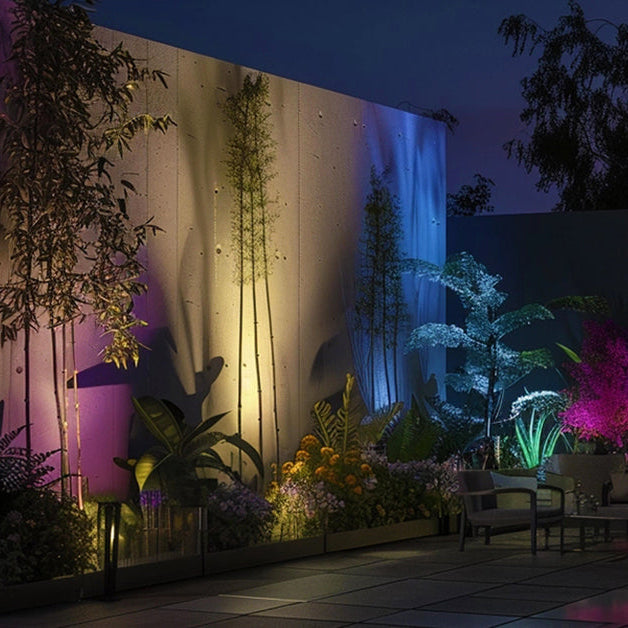 Aluminum RGB light scene with several ground fixtures casting color onto trees, a garden wall, and surrounding greenery.