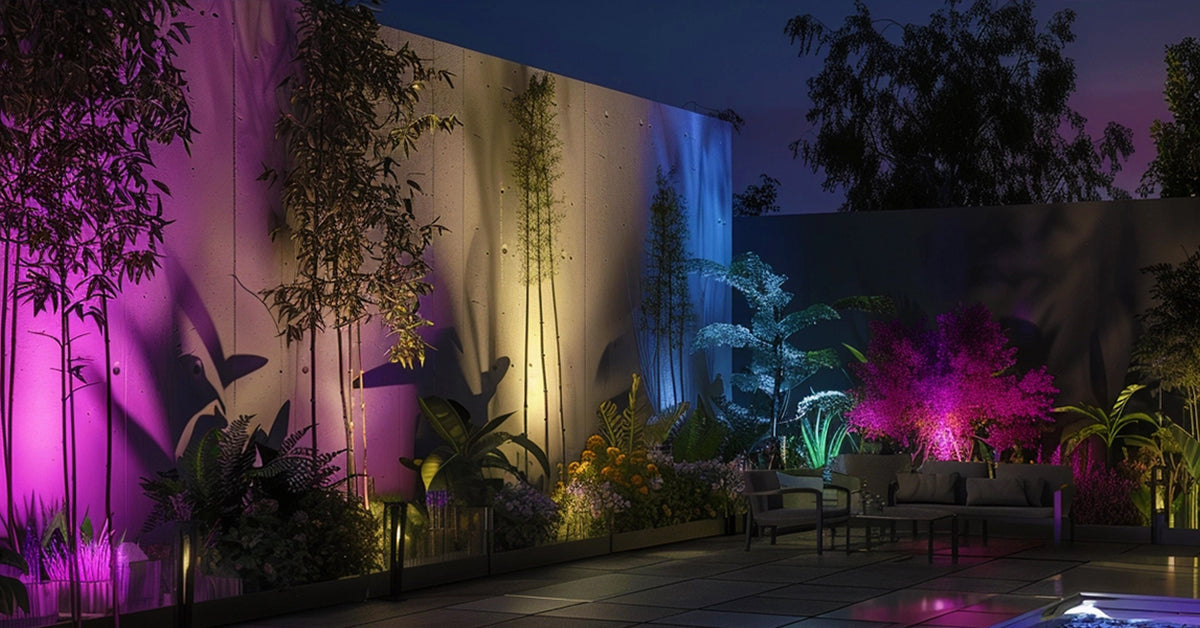 Aluminum RGB light scene with several ground fixtures casting color onto trees, a garden wall, and surrounding greenery.