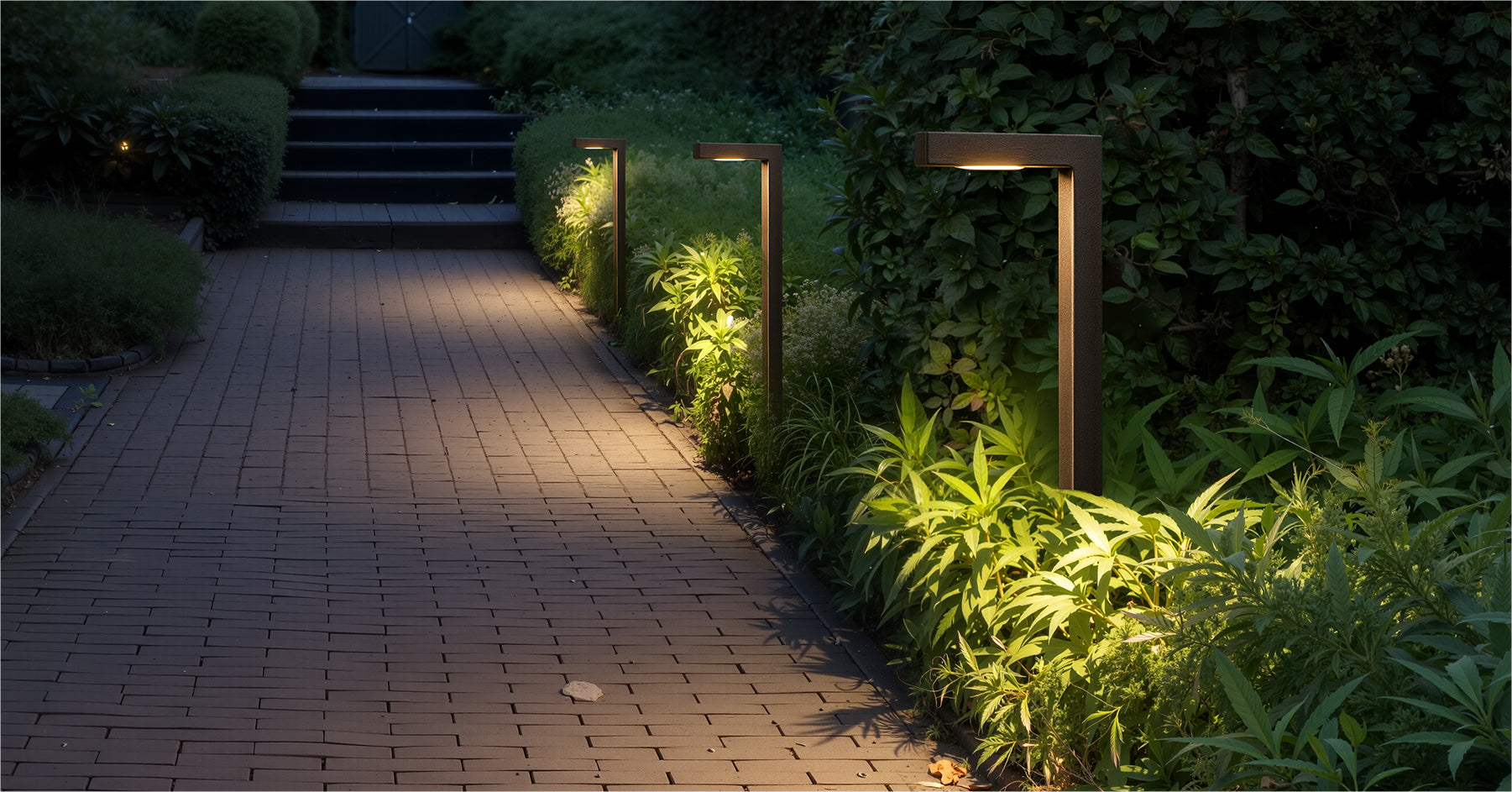 Path lights scene with several L-shaped fixtures aligned along a walkway, enhancing nighttime path safety.